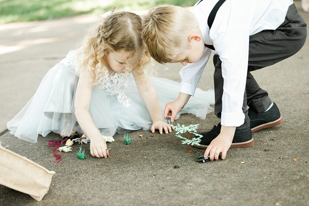 flower girl and ring boy playing outside 