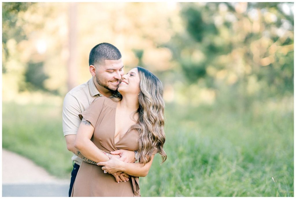 Engagement Photos at the Houston Arboretum couple hugging